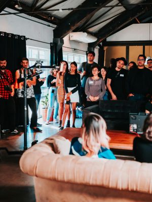 Vibrant business seminar in São Paulo with a diverse audience engaged in a speaker's presentation.